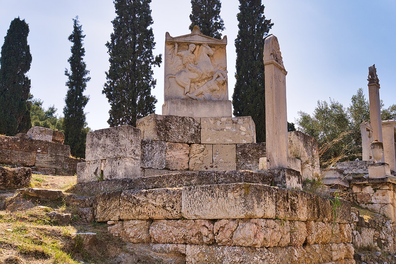 replica grave stele on the Street of Tombs at Kerameikos (checked: original writer marker named the Stele of Hegeso, but that original is at the National Archaeological Museum, not Kerameikos - used the neighbouring Dexileos stele replica instead, which the article text also names and which genuinely stands in situ at Kerameikos)